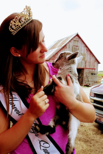 When is a young female goat old enough to breed?